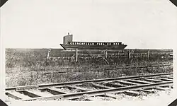 A coal barge lying upon a field of grass