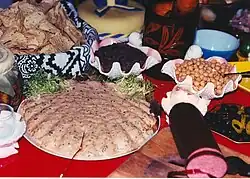 Molded seafood dip garnished with chicory "seaweed" and appetizers served in large sea shells