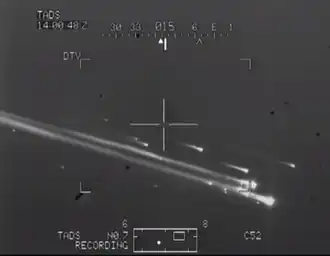 Grayscale photo of Columbia breaking apart in the air