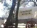 Covered wagon sign attracts motorists off Highway 97 to the Longhorn Museum in Pleasanton.