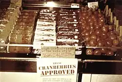 a display of cranberries with a sign labeling them as "approved"