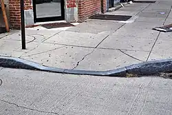 Sidewalk granite curb cut for wheelchair ramp
