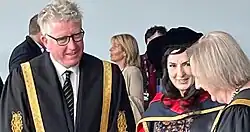This is a shot of Moya Doherty after receipt of an honorary doctorate from DCU, with the university's president and its chancellor to either side, as taken in May 2022
