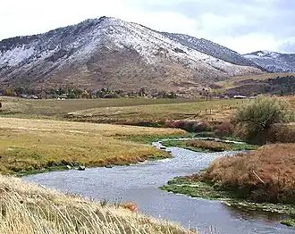 A small river meandering through grassland