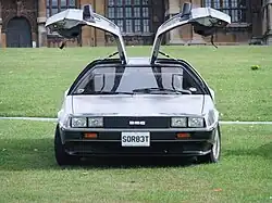 Front facing image of the DeLorean with the gull-wing doors open