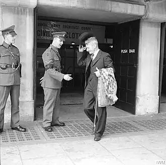 Mr Bill Krepper, late of the Pioneer Corps, leaves the demobilisation clothing depot at Olympia, London, wearing his demob suit.