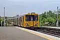 A Merseyrail Class 508 departs from the station.