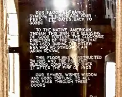 Door inscription that explains that the counter-clockwise swastika pattern is a symbol of good fortune to Native American people and intended as such by the club.