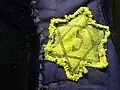 Detail of Jewish star on padded jacket