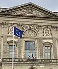 The European Flag is placed on numerous municipal flagpoles in Paris, on a par with the flag of France; here in front of the Louvre Palace (flown upside down).