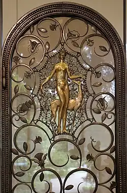 The foliage scroll – Elevator doors, by Brandt (1926), wrought iron, glass, patinated and gilded bronze, Calouste Gulbenkian Museum, Lisbon[116]