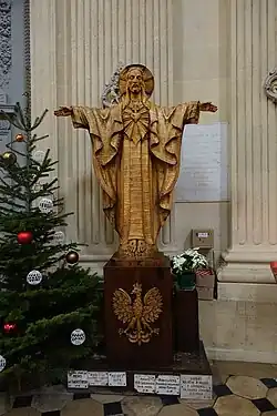 Sculpture of Christ above a Polish emblem