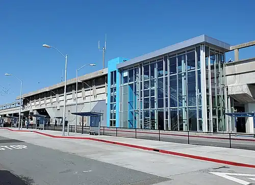 A elevated concrete and glass railway station seen from below