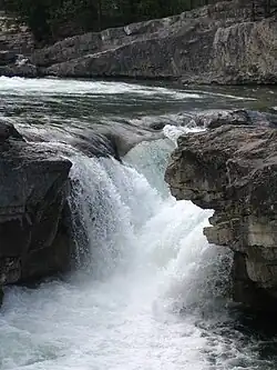 Elbow Falls flows over a Cadomin Formation outcrop.