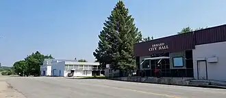 Two buildings on a county highway, one of which is labeled Erhard City Hall.