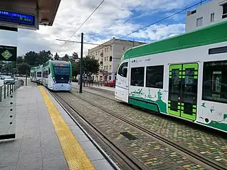 Tram-trains stopping at Reyes Católicos station