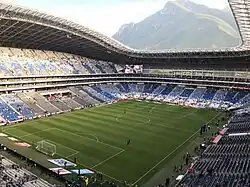 View of Cerro de la Silla from inside Estadio BBVA. It is a soccer stadium with a large mountain standing over the stadium.