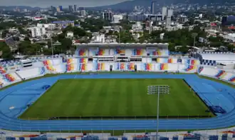 National Stadium Jorge "El Mágico" González with the San Salvador Financial District in the background.