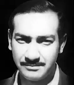 b/w strong contrast image of an indian male with dark hair and moustache