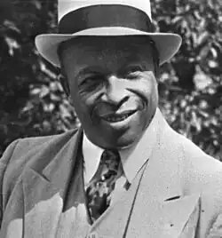 Father Divine, a middle-aged African-American man.