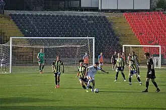 Fatih Karagümrük (white) in the home match against Fenerbahçe (navy/yellow) of the 2021-22 Turkish Women's Football Super League play-offs.