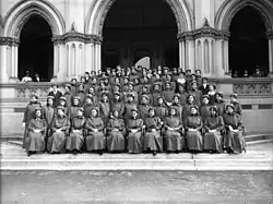 Group portrait of the first 69 nurses and 11 staff to leave for World War I. Taken on the steps of the General Assembly Library, Wellington, by an unidentified photographer for The Press newspaper of Christchurch.