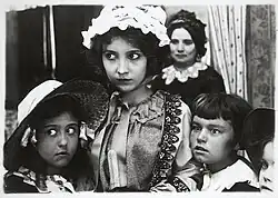 Film still showing Bessie Love and children