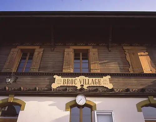 Two-story wooden station building with a station signage