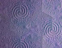 Three full designs can be seen when multiple tiles are laid in a certain pattern.