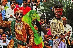 Bhanjara gypsy trader boasting while wife and Budia figure shrug