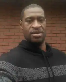 Selfie of Floyd wearing a black and gray hoodie