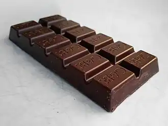 A block of dark chocolate, each segment engraved with "G&B's"