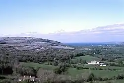 Gregan's Castle Hotel (mid-foreground) and the valley to Ballyvaughan from Corkscrew Hill, the Burren. The hill of the left (west) is Cappanawalla.