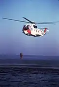 U.S. Coast Guard HH-3F Pelican hoists a swimmer, the first helicopter used for rescue swimming.