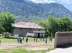 Kids playing soccer on Higher Scondary School 33 Note playing field.