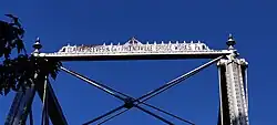 A photograph of an inscription of the names of the fabricators of the bridge, located on top of one of its entryways. It reads: "CLARKE, REEVES & Co. PHOENIXVILLE BRIDGE WORKS. Pa."
