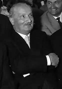 Black-and-white photo of a man wearing a suit and a tie