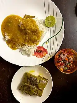 Homemade dal and rice meal with Bhetki paturi and salad
