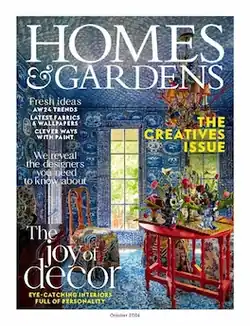 Cover of Homes & Gardens magazine showing tables and chairs with flowers on the top of a round table