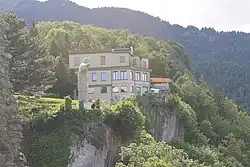 Hotel Wartenstein Castle with Jesus statue. View from the ruins of Wartenstein Castle.