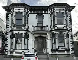 Photo of large wooden house with elaborate details