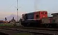 BB 200-03 locomotive waiting for departure signal at the station. Mount Merapi is visible at the background, while Mount Merbabu is hindered by the locomotive