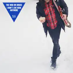 A person in mid-stride with their head out of frame on an off-white background; the band and album name are at top left