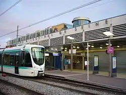 Tram stop with entrance the RER station behind