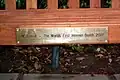 The bench's bottom plaque