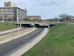 A view of Interstate 375, showing both carriageways of the freeway and an overpass with a sign for Larned Street.