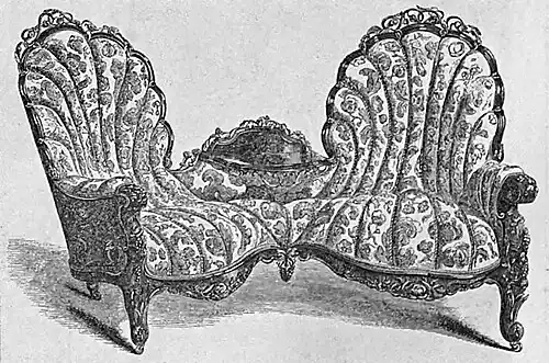 Confidant or tête-à-tête carved in black walnut and covered in crimson and gold damask by J. & W. Hilton