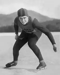 Jack Shea wearing a speed-skating outfit on top of a frozen lake, a mountain can be seen in the background.