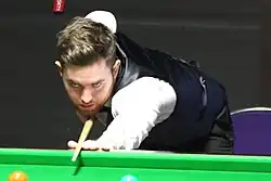 Jak Jones playing a shot