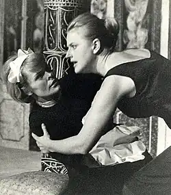 Two actors performing on stage in a theatrical production